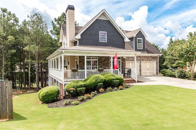 view of front of home with a front yard, driveway, covered porch, a chimney, and stone siding