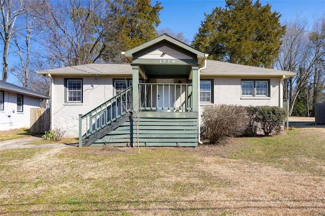 bungalow-style house with covered porch and a front yard