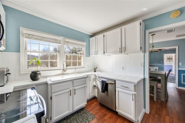 kitchen with sink, appliances with stainless steel finishes, ornamental molding, white cabinets, and dark hardwood / wood-style flooring