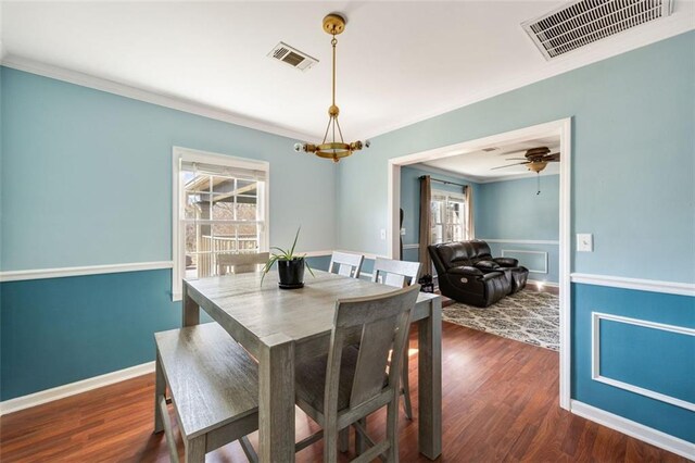 kitchen featuring dark hardwood / wood-style floors, ornamental molding, stainless steel fridge, and white cabinets