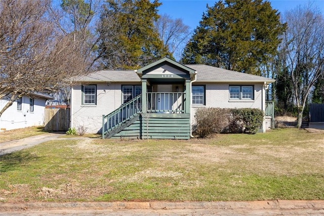 bungalow with a front yard and covered porch