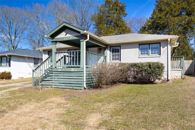 bungalow-style home featuring a porch and a front yard