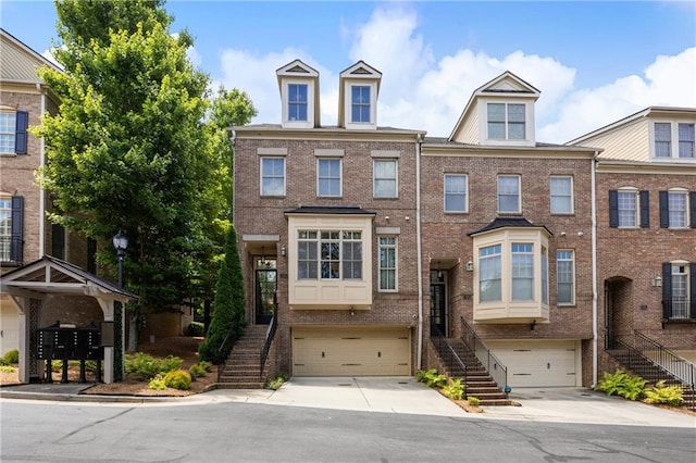 538 Sarabrook Pl, Sandy Springs, GA 30342 - townhome / multi-family property with stairs, an attached garage, driveway, and brick siding