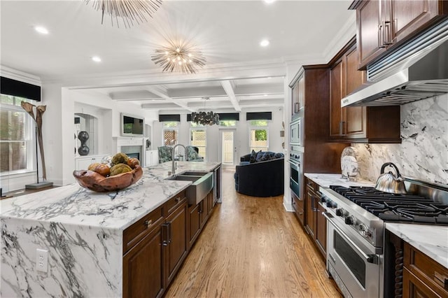 538 Sarabrook Pl, Sandy Springs, GA 30342 - kitchen with appliances with stainless steel finishes, open floor plan, extractor fan, light wood-style floors, and recessed lighting