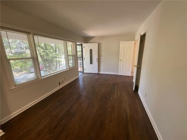 unfurnished room with dark hardwood / wood-style floors