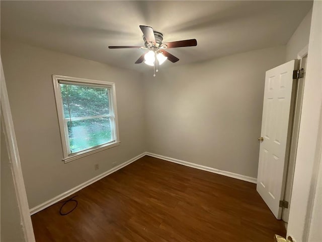 empty room featuring ceiling fan and dark hardwood / wood-style flooring