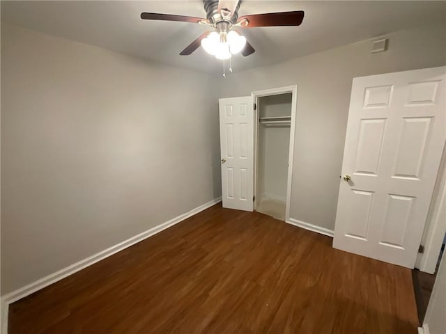 unfurnished bedroom with ceiling fan and dark hardwood / wood-style floors