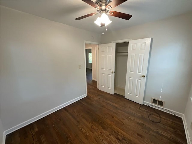 unfurnished bedroom featuring dark hardwood / wood-style flooring, a closet, and ceiling fan