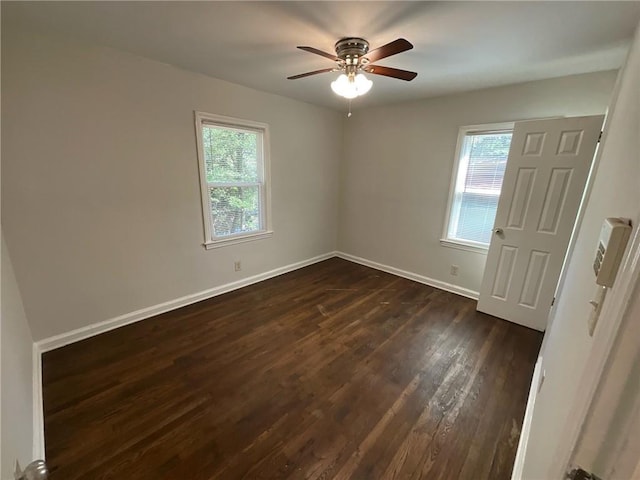 spare room featuring ceiling fan and dark wood-type flooring