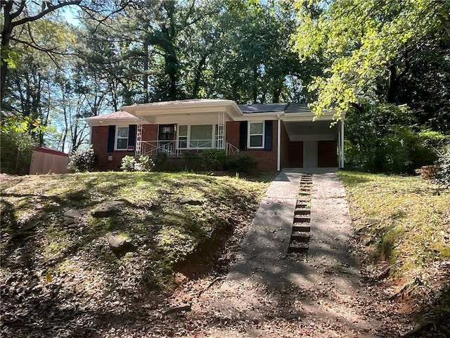 ranch-style house with covered porch and a carport