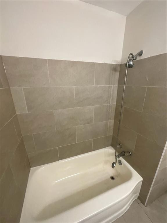 bathroom featuring tile patterned flooring and tiled shower / bath combo