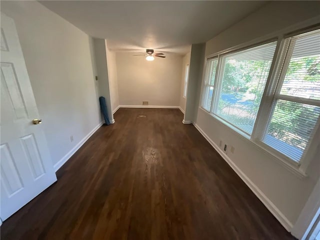 interior space featuring ceiling fan and dark hardwood / wood-style flooring