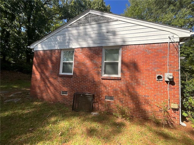 view of side of home with a lawn