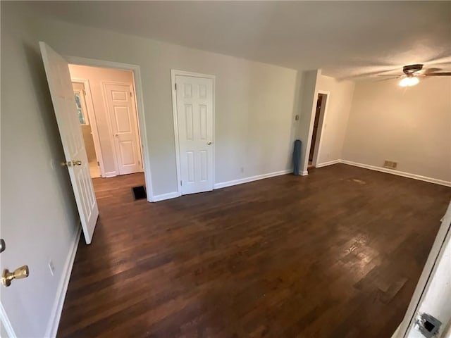 spare room featuring ceiling fan and dark hardwood / wood-style flooring