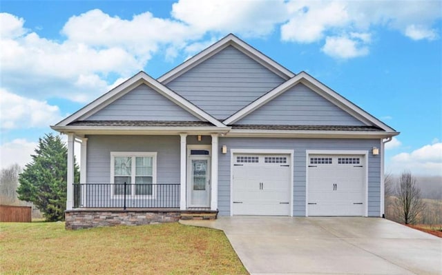 craftsman house featuring a garage, a porch, and a front lawn