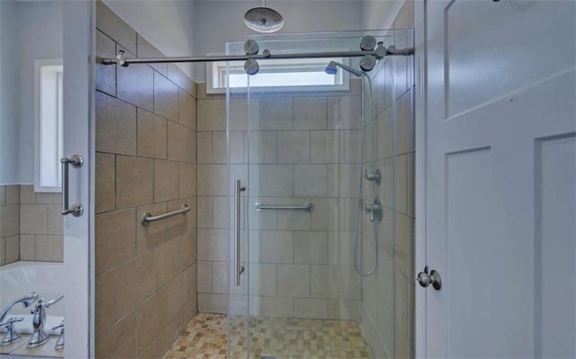 bathroom with a shower with door