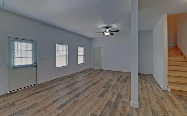 unfurnished living room featuring ceiling fan and hardwood / wood-style floors