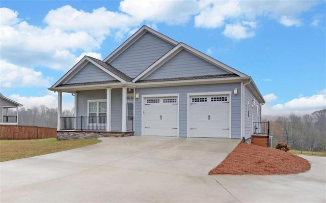 craftsman inspired home featuring a garage and covered porch