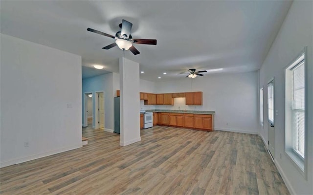 kitchen with electric stove, fridge, ceiling fan, and light hardwood / wood-style floors