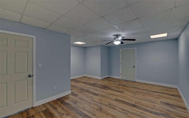 unfurnished room with hardwood / wood-style flooring, a paneled ceiling, and ceiling fan