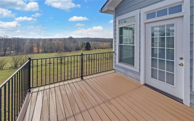 wooden deck featuring a lawn