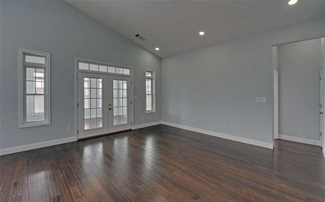 spare room with high vaulted ceiling, dark hardwood / wood-style flooring, and french doors