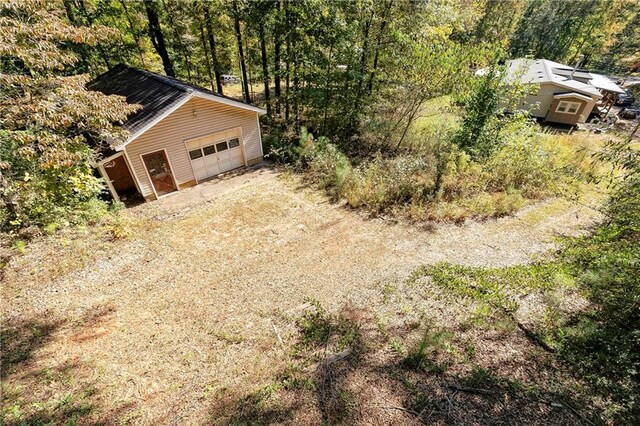 255 Shipp Cir, Hiram, GA 30141 - detached garage with dirt driveway and a wooded view