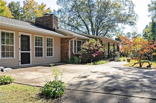 255 Shipp Cir, Hiram, GA 30141 - back of property with a patio area, a chimney, roof with shingles, and brick siding