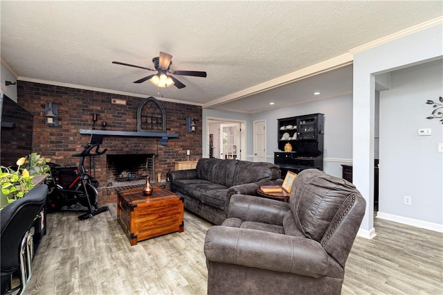 255 Shipp Cir, Hiram, GA 30141 - living room with wood finished floors, ceiling fan, a textured ceiling, baseboards, and a brick fireplace