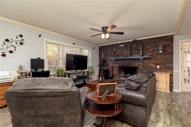 255 Shipp Cir, Hiram, GA 30141 - living room featuring wood finished floors, ceiling fan, ornamental molding, a fireplace, and a textured ceiling
