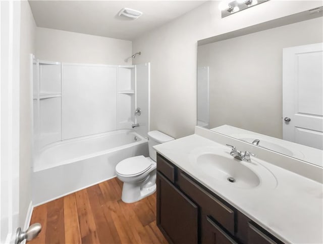 full bathroom with toilet, wood-type flooring, vanity, and bathing tub / shower combination