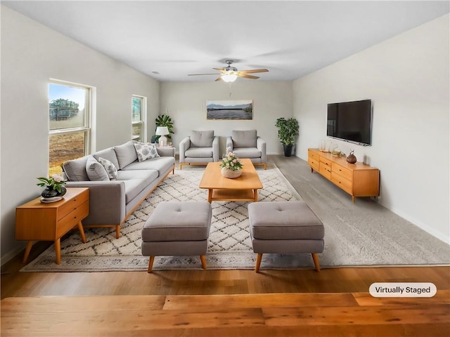 living room featuring ceiling fan and hardwood / wood-style flooring