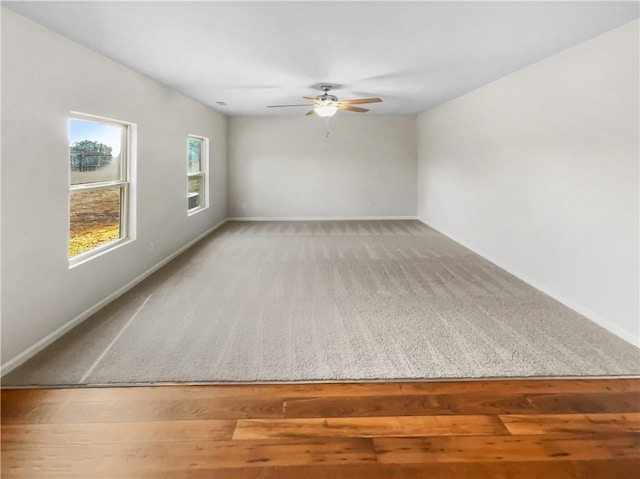 carpeted spare room featuring ceiling fan