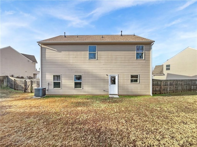 back of property with a lawn and cooling unit