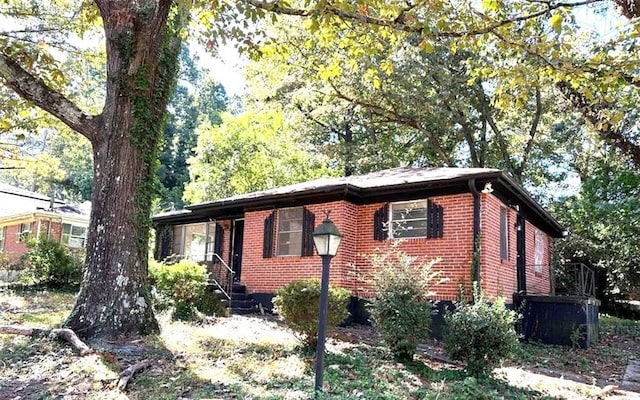 view of side of property featuring brick siding