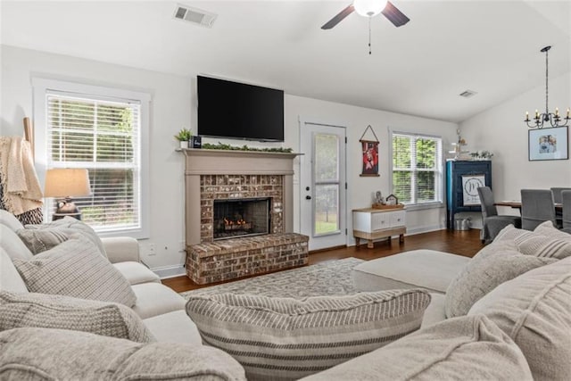 1081 Oak Hill Ln, Madison, GA 30650 - living room with a fireplace, ceiling fan, vaulted ceiling, a chandelier, and wood finished floors