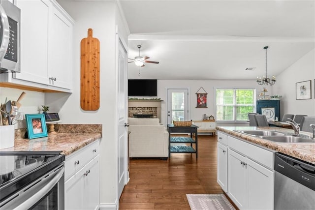 1081 Oak Hill Ln, Madison, GA 30650 - kitchen featuring appliances with stainless steel finishes, a brick fireplace, a sink, and open floor plan