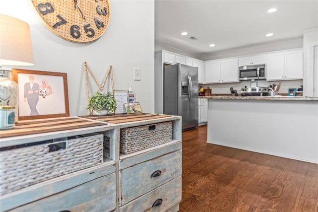 1081 Oak Hill Ln, Madison, GA 30650 - kitchen with appliances with stainless steel finishes, white cabinetry, dark wood-type flooring, and recessed lighting