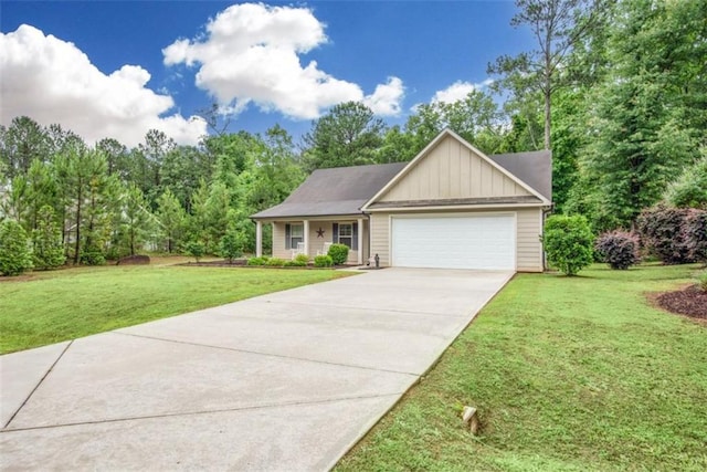 1081 Oak Hill Ln, Madison, GA 30650 - view of front of home with board and batten siding, a garage, a front yard, and driveway
