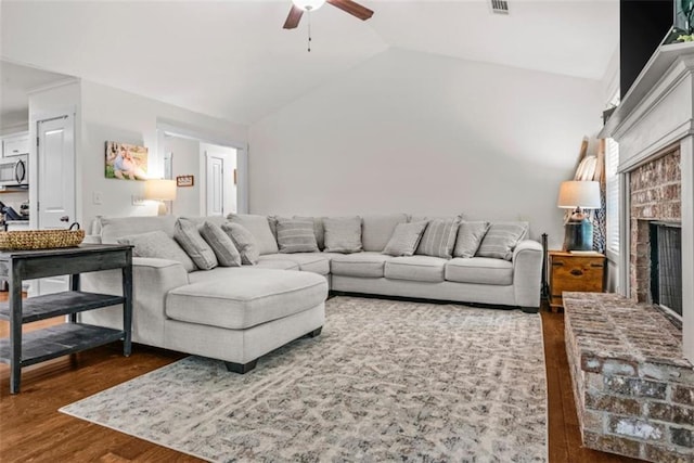 1081 Oak Hill Ln, Madison, GA 30650 - living area featuring dark wood-style floors, a ceiling fan, vaulted ceiling, and a fireplace