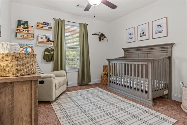 1081 Oak Hill Ln, Madison, GA 30650 - carpeted bedroom with a crib, baseboards, and ceiling fan