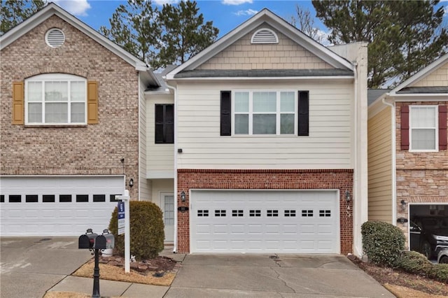 view of property featuring concrete driveway, brick siding, and an attached garage