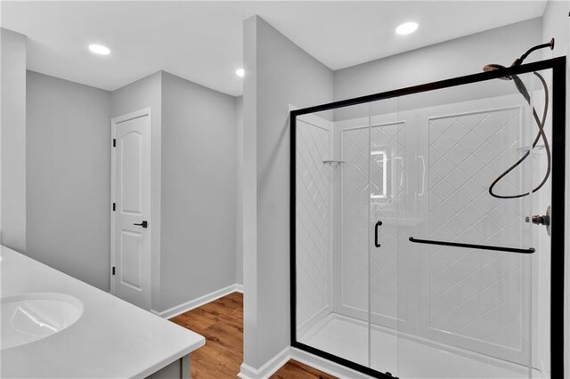 full bathroom featuring a stall shower, wood finished floors, and recessed lighting