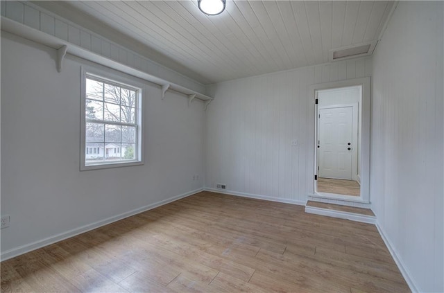 spare room with light hardwood / wood-style flooring