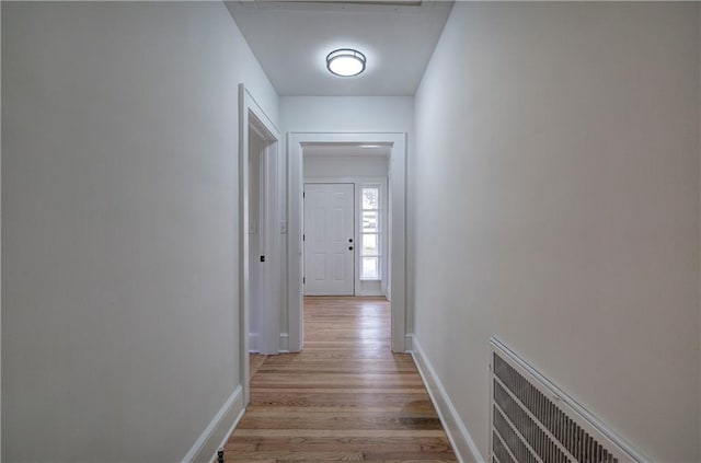 hallway with light hardwood / wood-style flooring