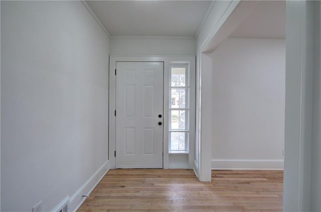 entrance foyer featuring plenty of natural light, light wood-type flooring, and crown molding