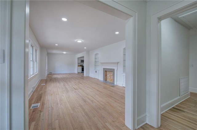 unfurnished living room with light hardwood / wood-style floors