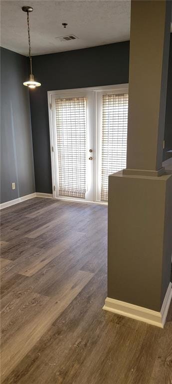 empty room with hardwood / wood-style floors and a textured ceiling