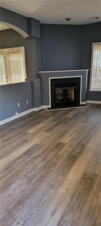 unfurnished living room featuring wood-type flooring