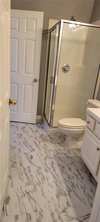 bathroom featuring toilet, vanity, and walk in shower